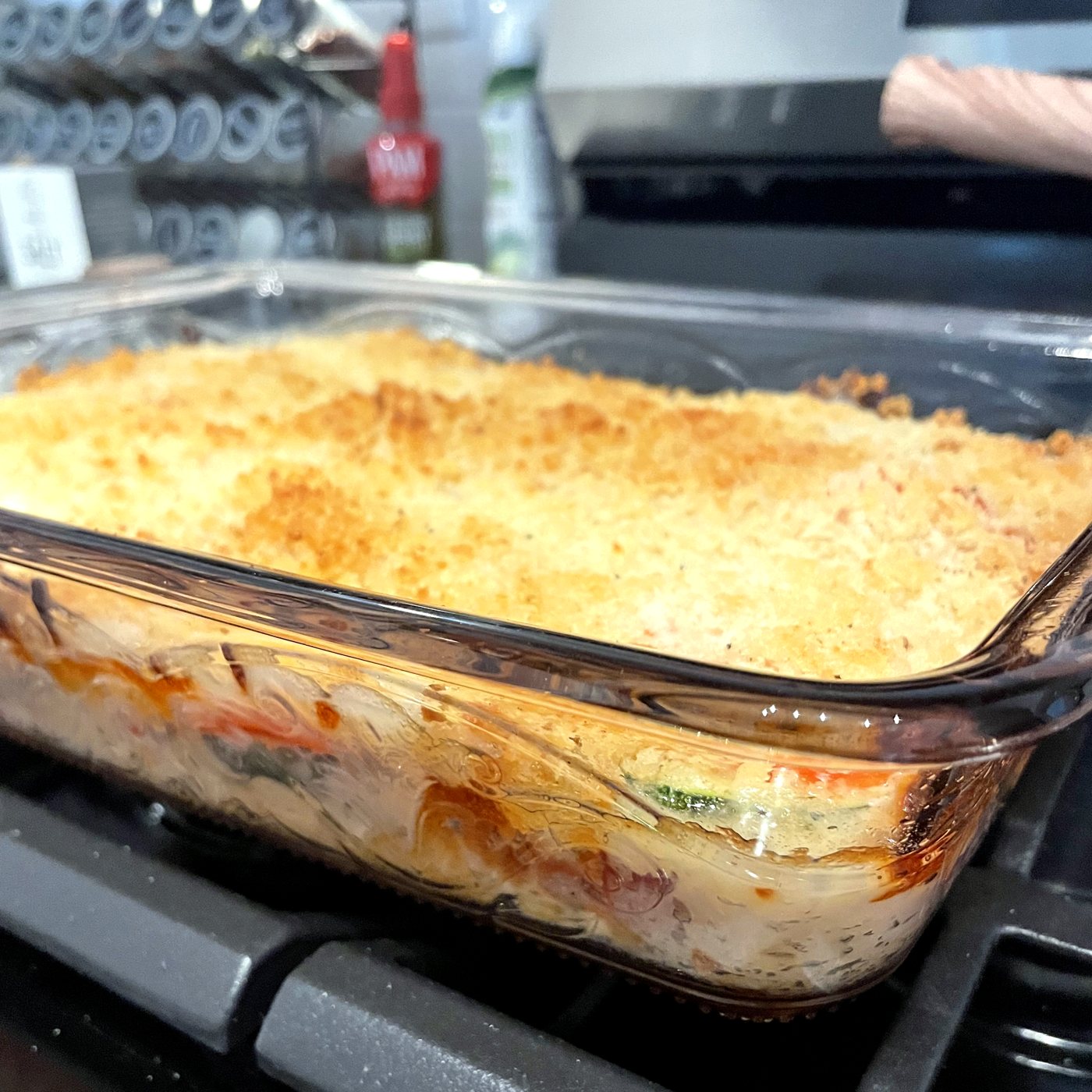 Zucchini tomato bake in a glass baking dish with a golden panko top